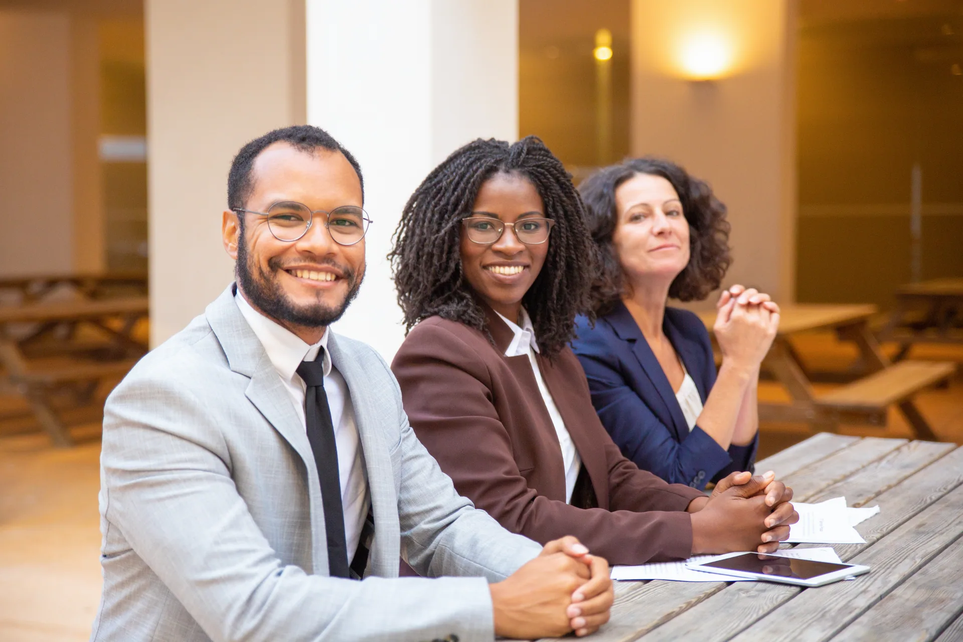 A diverse business team smiling during an outdoor meeting