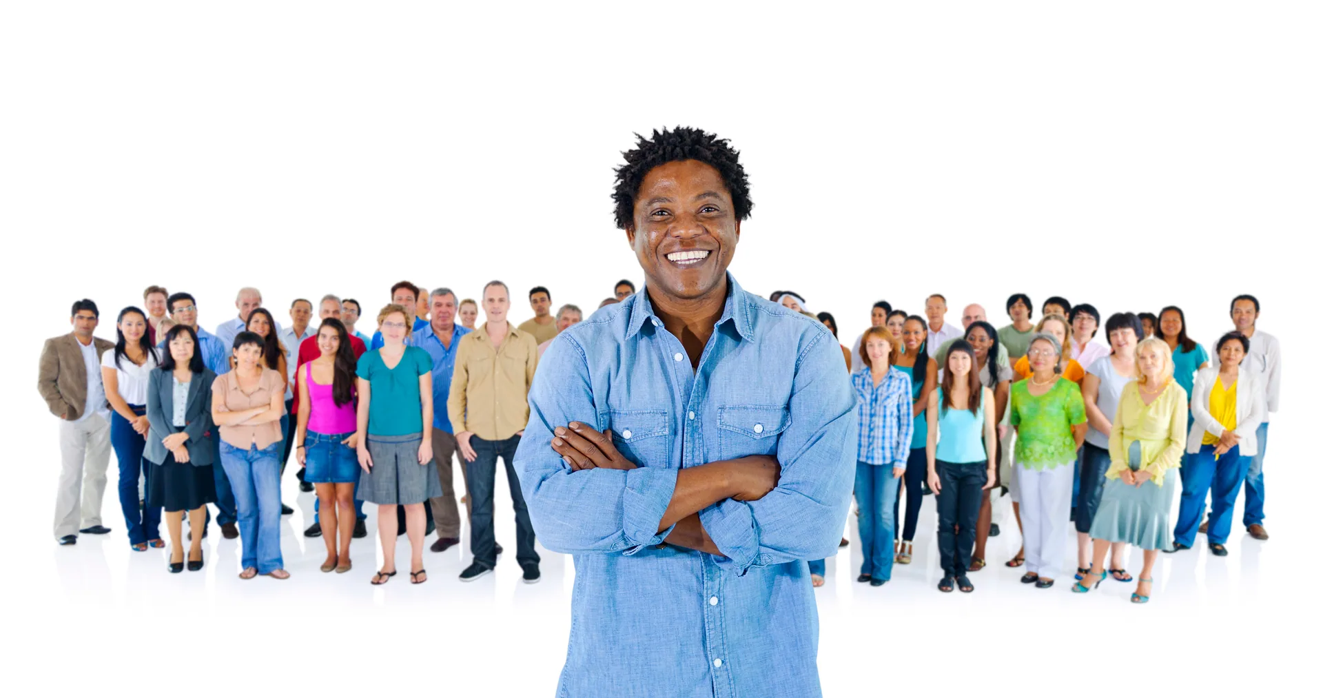 A smiling professional standing confidently before a diverse international community